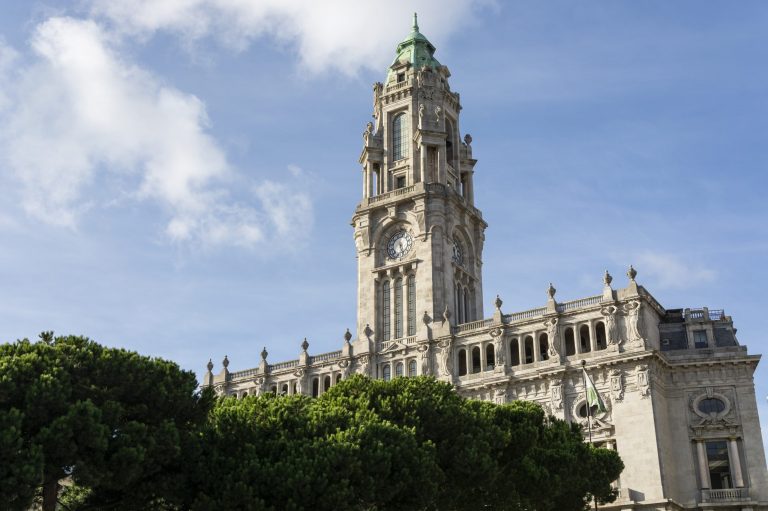 Porto City Hall. Pine trees. Blue sky with clouds. Tower.